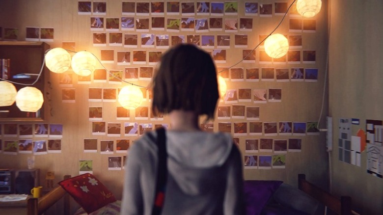 Girl looks at photo wall