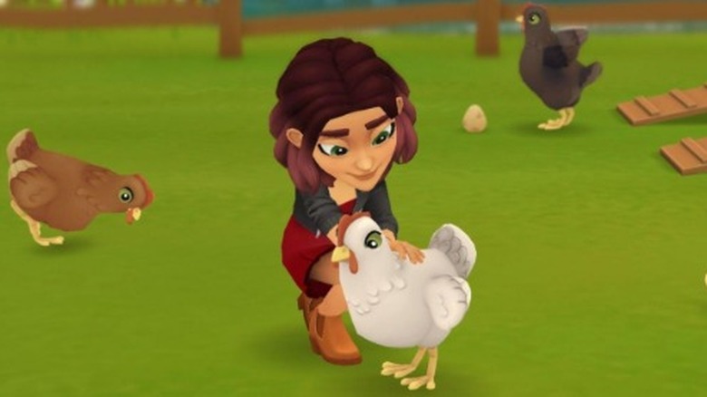 Tara petting chicken