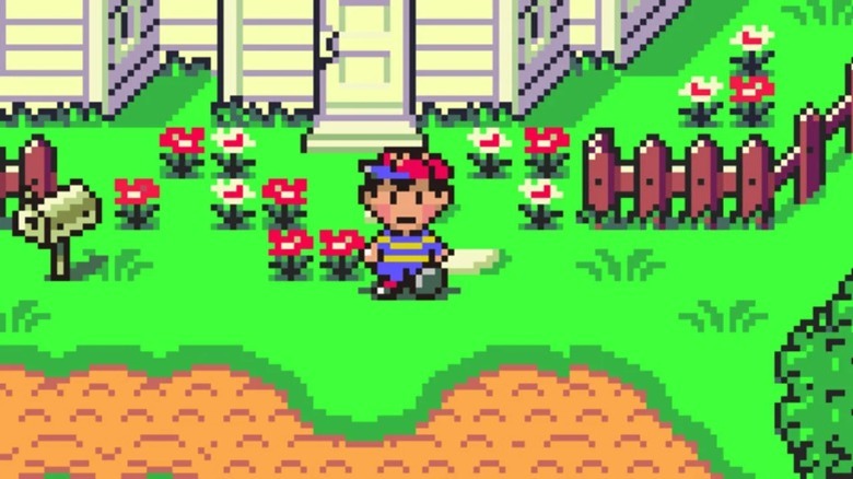 Nes standing in front of his house