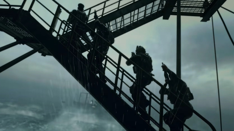 Soldiers walking up stairs of ocean platform