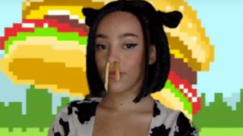 Doja Cat with fries in her nose