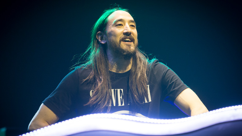 Steve Aoki behind a DJ booth