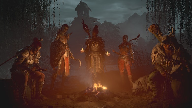 Diablo 4 classes sitting by bonfire