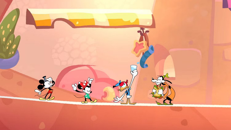 Mickey, Minnie, Donald, and Goofy standing in a desert environment