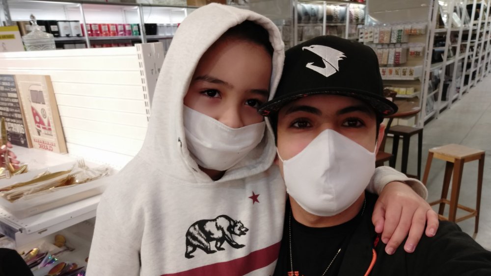 Zenon and his dad pose together while wearing masks
