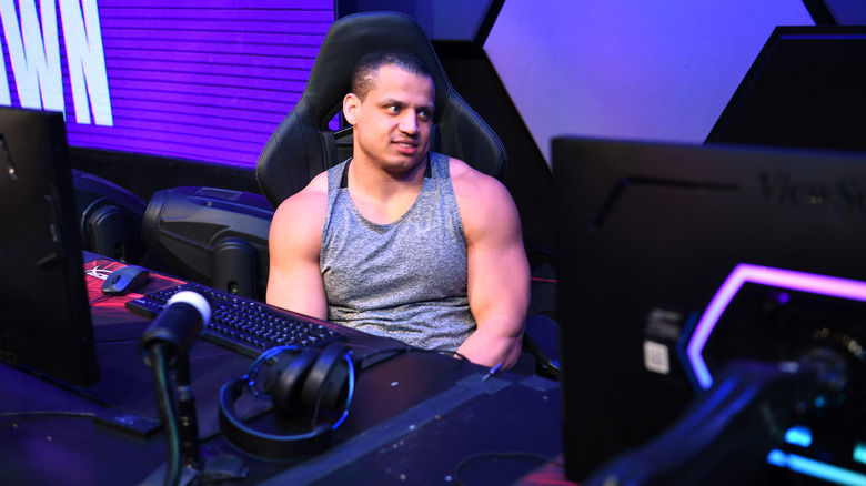 Tyler1 looks at other players during an esports event