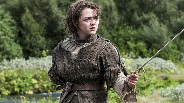 Arya holding out sword