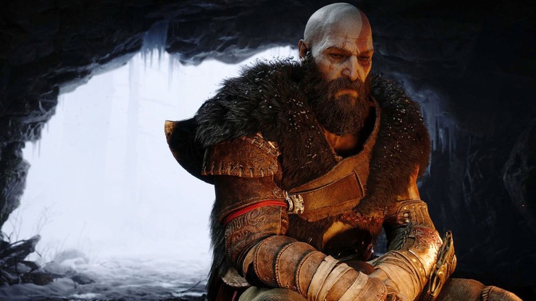 Kratos sitting by fire