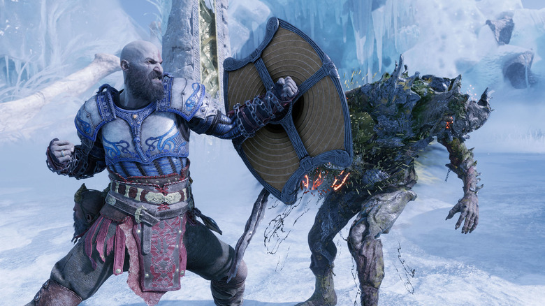 Kratos striking monster with his shield