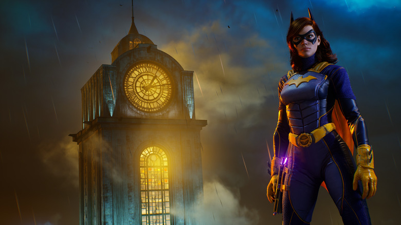 A screenshot from Gotham Knights, showing Batgirl standing in front of a clocktower. The clocktower is aglow with light, and it's raining.