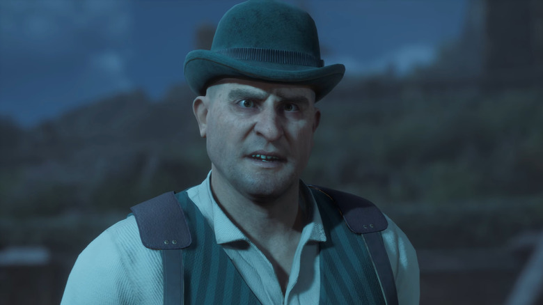 man with green bowling cap and suspenders