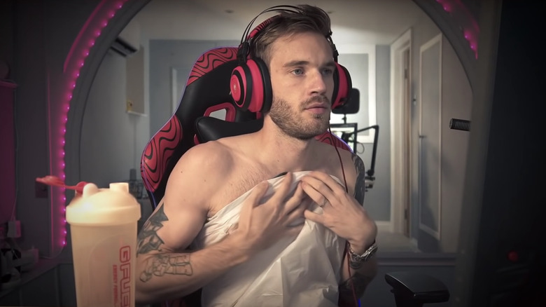 PewDiePie holds a bag over his chest