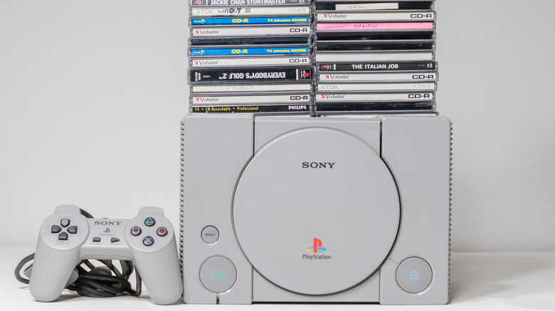 A PS1, controller, and variety of games