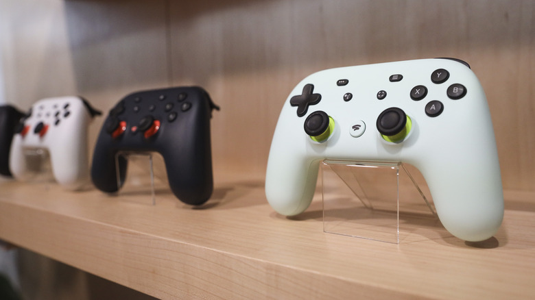 Stadia controllers on wooden shelf