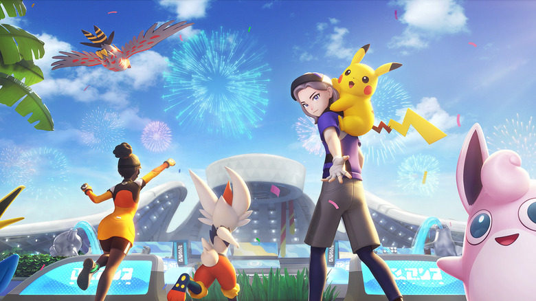 Pokemon Unite trainers celebrating with Pokemon
