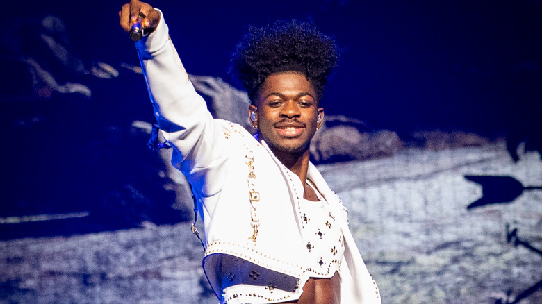 Lil Nas X posing with mic during performance