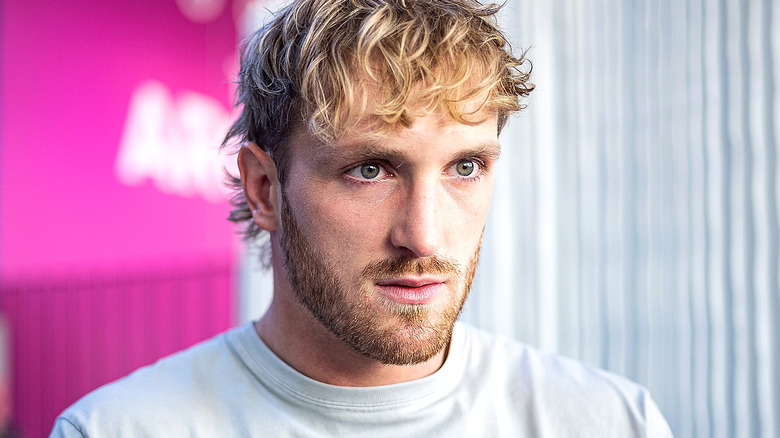 Logan Paul staring pink background