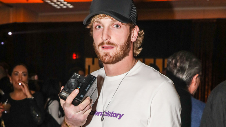 Logan paul with polaroid