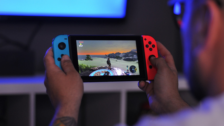 Man playing The Legend of Zelda: Breath of the Wild on Nintendo Switch