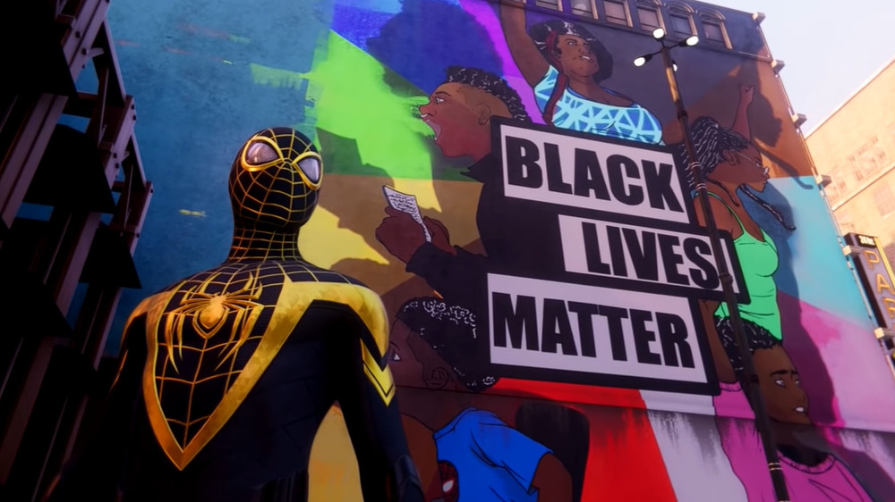 Miles beside a Black Lives Matter street art piece
