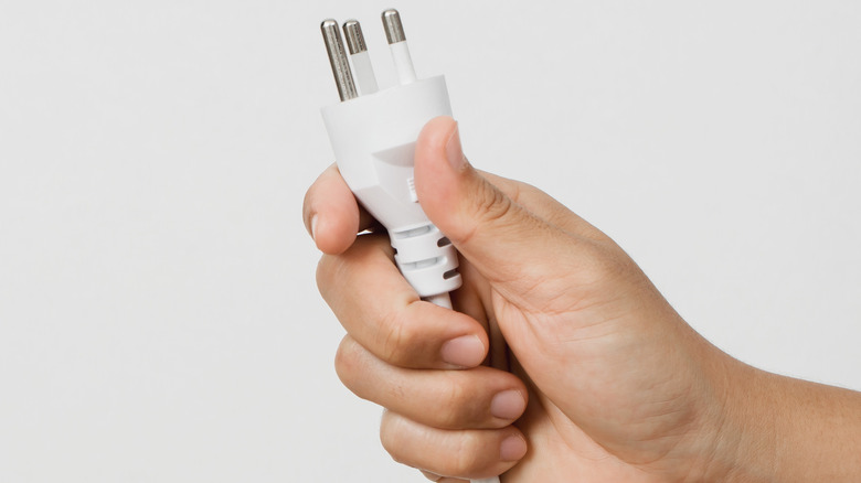 Person holding plug