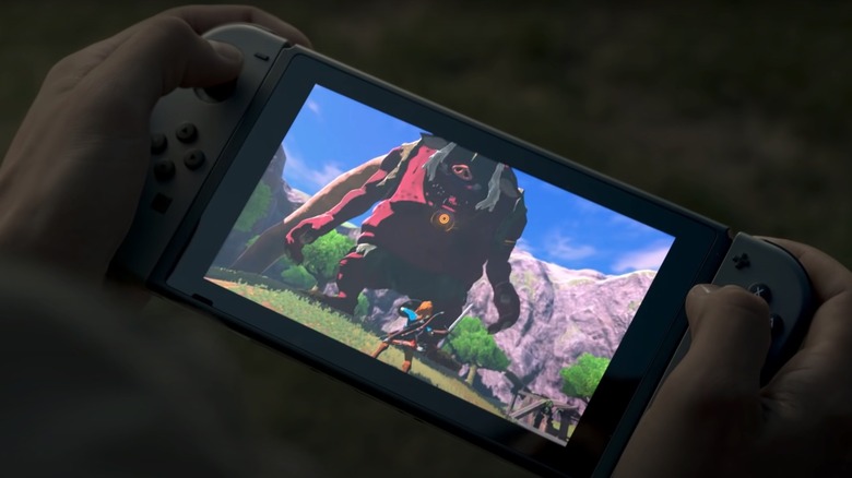 Holding a Nintendo Switch