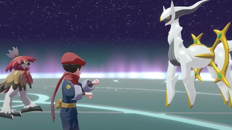 Decidueye and Pokemon trainer bracing themselves in front of Arceus