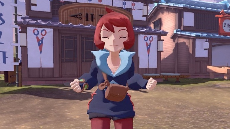 A smiling female character with dark blue clothes and red hair