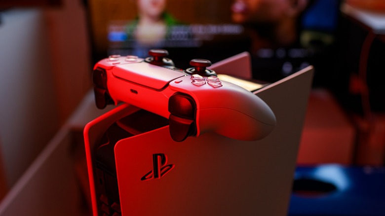 PS5 and controller displayed in red light
