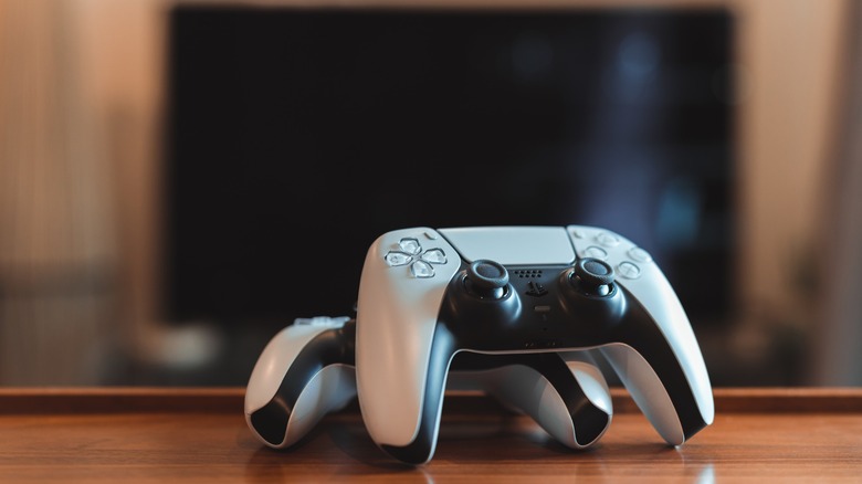 Two DualSense controllers sitting on table