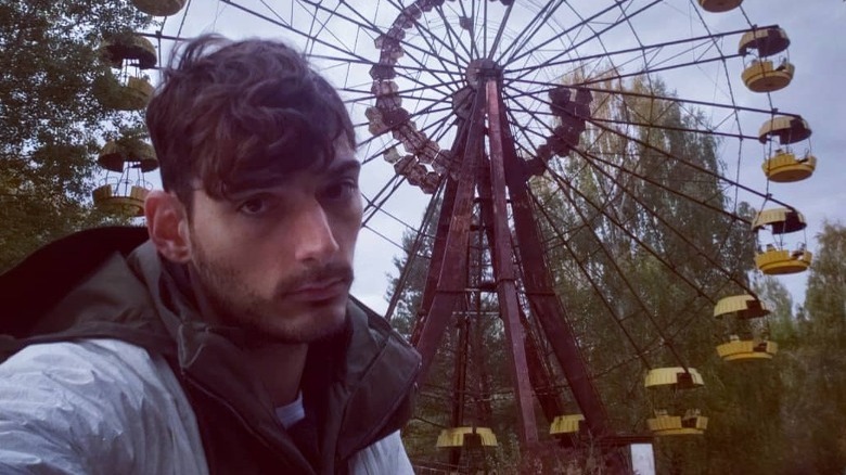 Ice Poseidon selfie in front of Ferris wheel