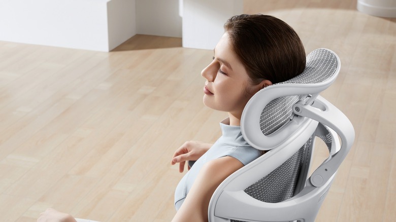 Person leaning back and resting in white Doro C300 Series chair