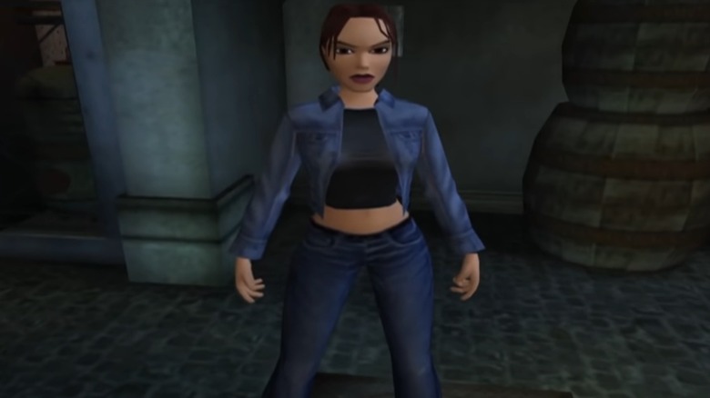 Lara Croft stands by barrels