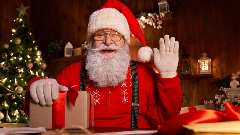 Santa waving with present