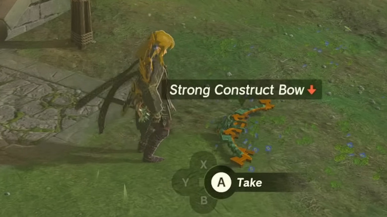 Link looking at a bow on the ground