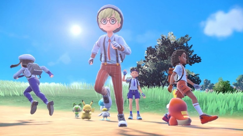 Pokémon trainers running in a field