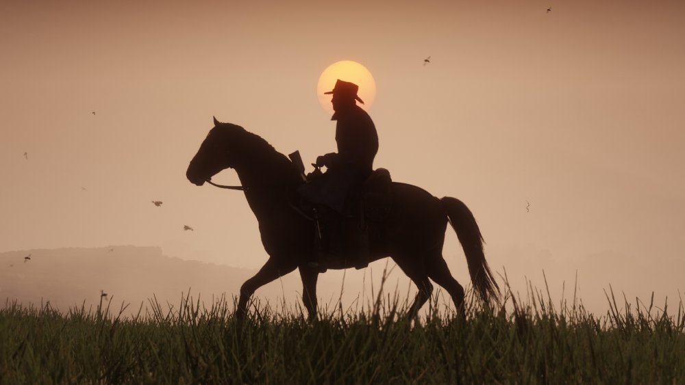 Arthur Morgan rides during the sunset