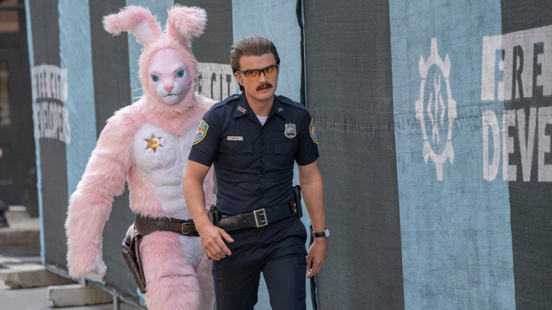 Joe Keery and Utkarsh Ambudkar in Free Guy dressed as a cop and a bunny
