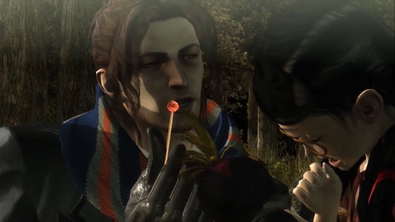 Luka offering Cereza a lollipop