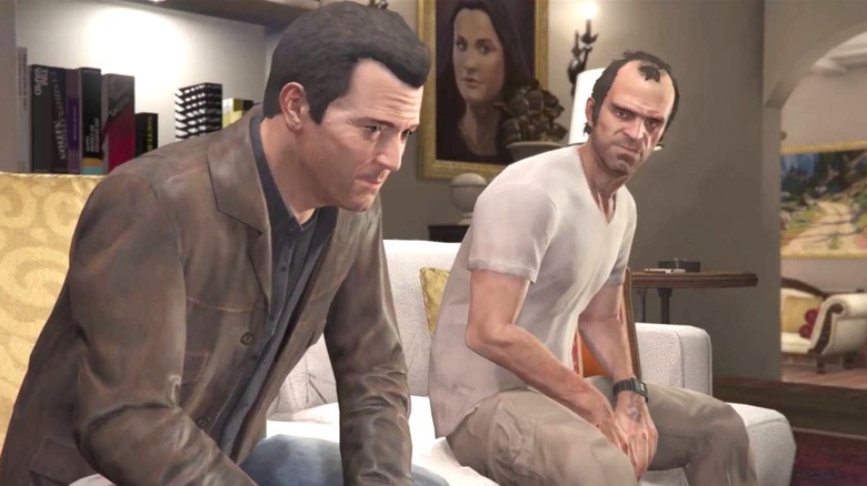 Michael and Trevor sit on a couch in a fancy house