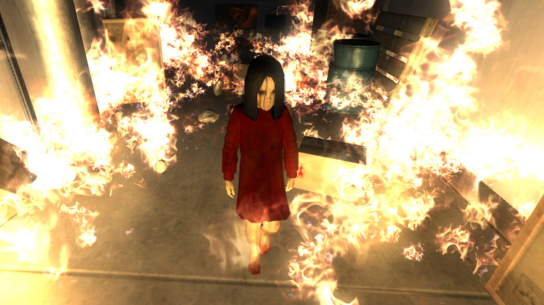 a young girl in a red coat near fire