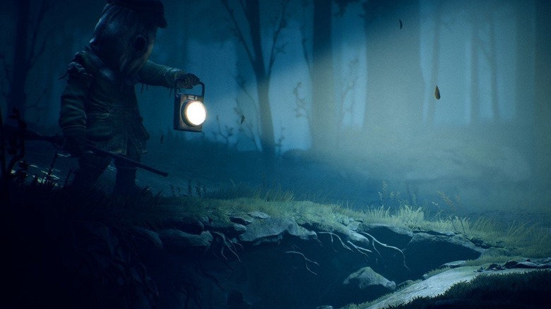 A child walks through a dark forest, holding a light