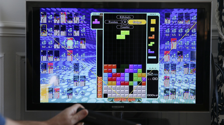 Someone playing Tetris on a screen