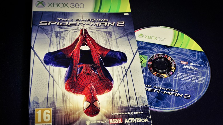 An image of the game box of The Amazing Spider-Man 2 for Xbox 360. The game disc is outside the box, on the right side of the image.