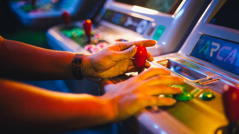 Player at arcade cabinet