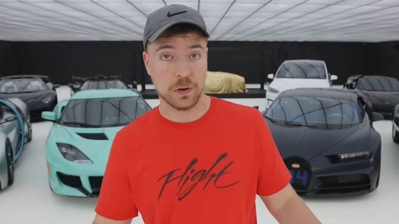 MrBeast standing in front of cars