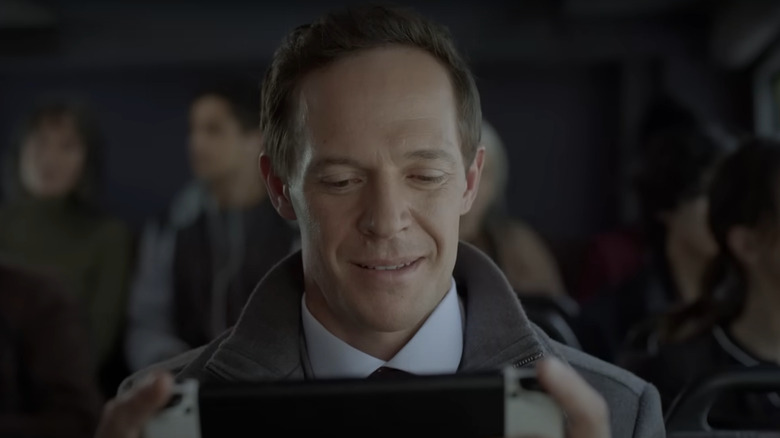 Sad Man smiling and playing Switch