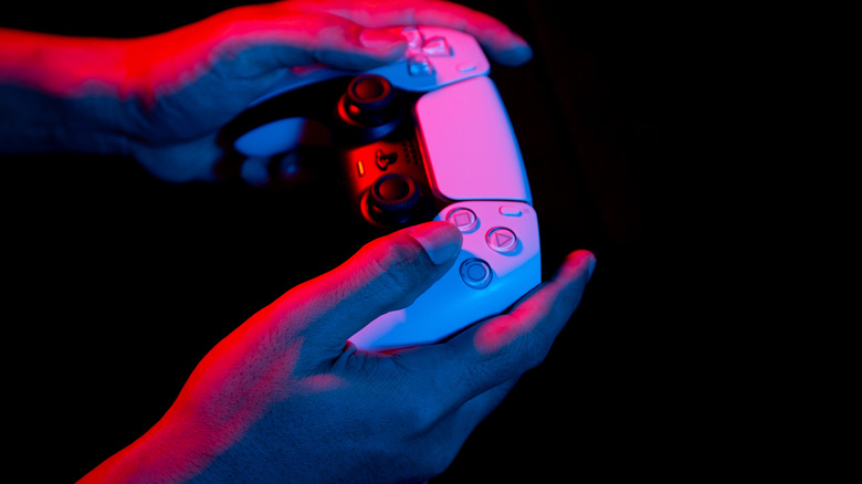 Controller in hands with red and blue lights