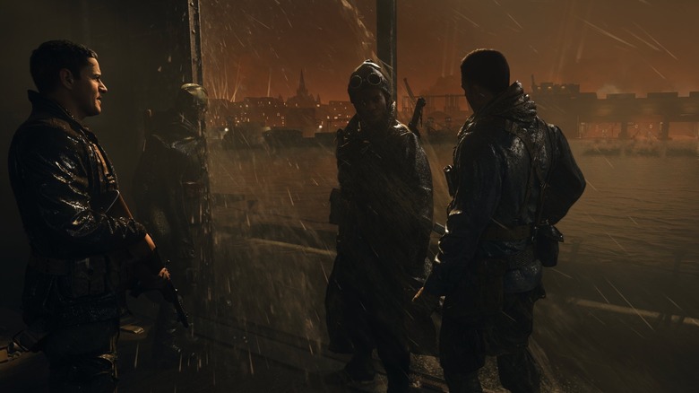 Four soldiers standing in rain