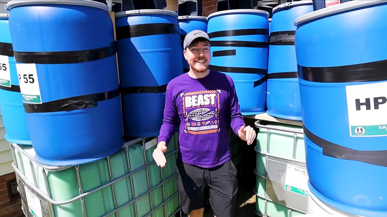 MrBeast standing by barrels